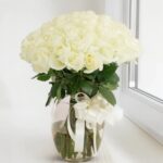 White Roses in Glass Vase